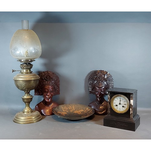 260 - A Victorian black slate mantle clock together with a pair of African carved busts, an oil lamp and a... 