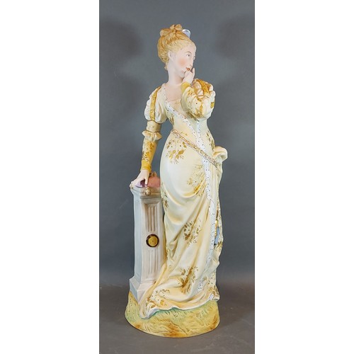 30 - A large early 20th Century figure in the form a a lady in period dress standing by a pillar, 52cms t... 