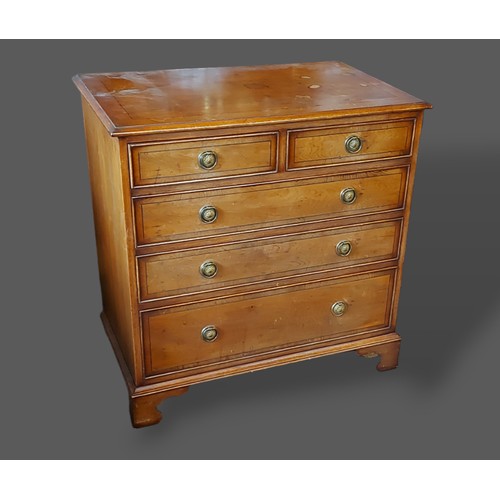 328 - A 20th Century chest of two short and three long drawers with circular brass handles raised upon bra... 