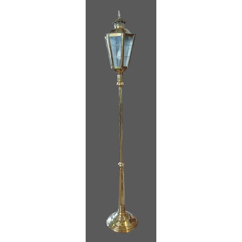 332 - A brass lamp standard in the form of a lantern with circular base, 180cms tall