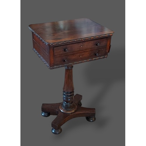 333 - A William IV Rosewood worktable with two drawers above a turned centre column raised upon a platform... 