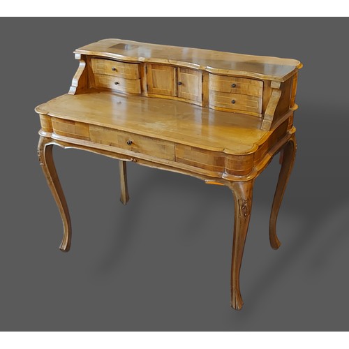 335 - A 19th Century Continental walnut writing table, the superstructure with four drawers and central cu... 