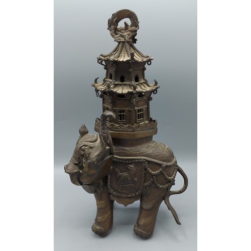 265 - A Chinese bronze incense burner in the form of a elephant with pagoda, 30cms tall