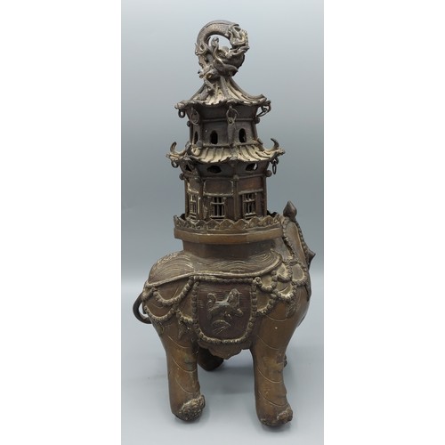 265 - A Chinese bronze incense burner in the form of a elephant with pagoda, 30cms tall