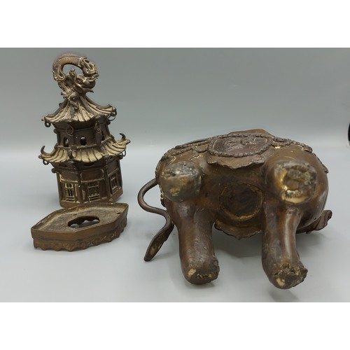 265 - A Chinese bronze incense burner in the form of a elephant with pagoda, 30cms tall