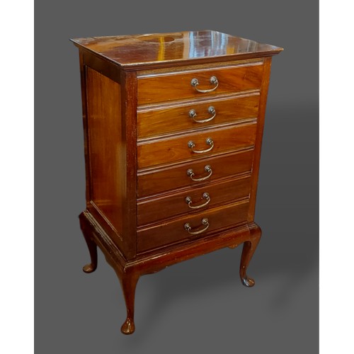 383 - An Edwardian mahogany six drawer music chest with brass handles raised upon cabriole legs together w... 