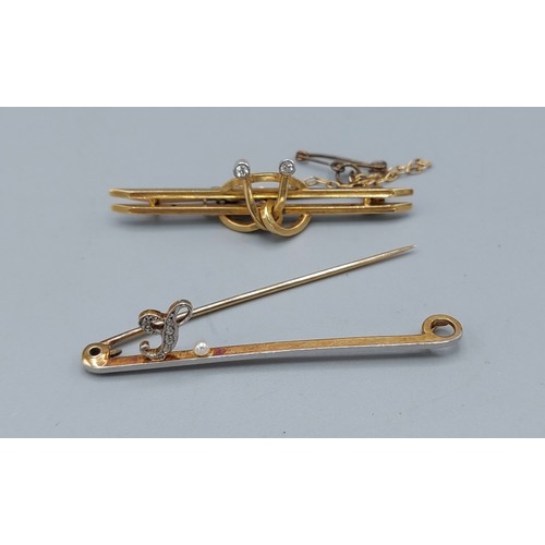 155 - A 15ct gold bar brooch set with a diamond encrusted L and a single pearl together with another 15ct ... 