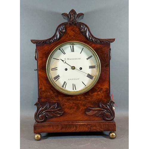 293 - A William IV mahogany case bracket clock, the carved shaped case with side ring handles, the dial in... 