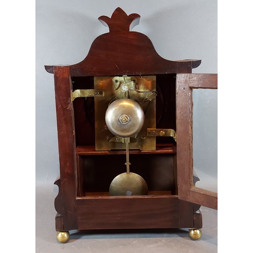 293 - A William IV mahogany case bracket clock, the carved shaped case with side ring handles, the dial in... 