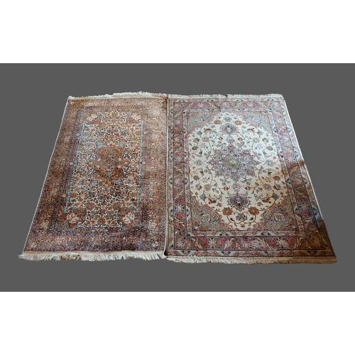 303 - An Indian Silk Rug with a central medallion within an all over design upon a cream, blue and red gro... 