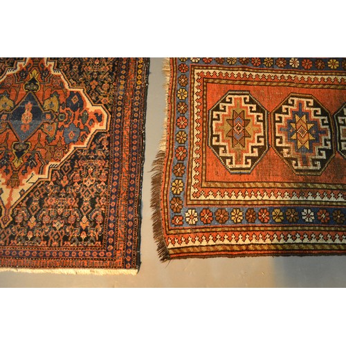 306 - A North West Persian Woollen Small Rug with four central guls within multiple borders, 121 x 79 cms ... 