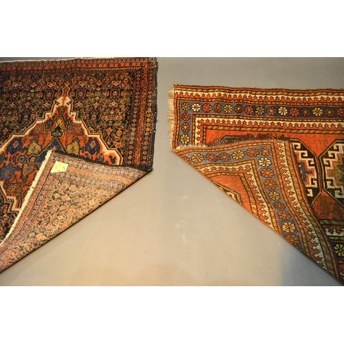 306 - A North West Persian Woollen Small Rug with four central guls within multiple borders, 121 x 79 cms ... 