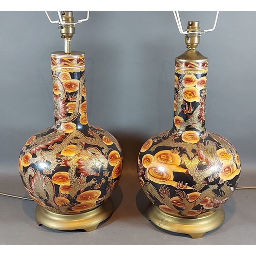 54 - A pair of table lamps, decorated with serpents, upon gilt metal bases, 40cms tall