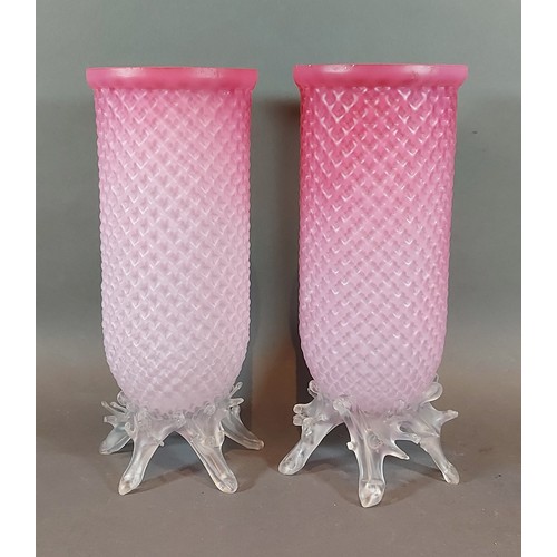 62 - A pair of early 20th Century pink glass storm vases with naturalistic clear glass bases, 24cms tall