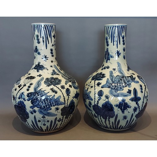 65 - A pair of Chinese underglaze blue decorated bottle neck large vases each decorated with carp amongst... 