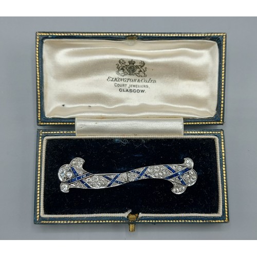 194 - An Art Deco platinum Sapphire and Diamond encrusted brooch of stylised form, 6cms long, 7.5cms