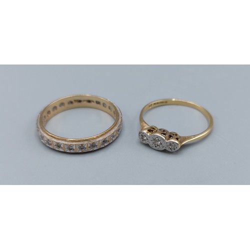 204 - An 18ct gold three stone Diamond ring, 1.5g, together with a 9ct gold diamond set eternity ring, 2.2... 