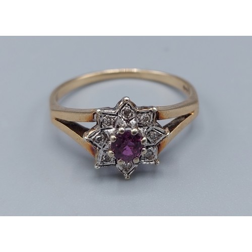 205 - A 9ct gold cluster ring set with a central Amethyst surrounded by diamonds within a pierced setting,... 