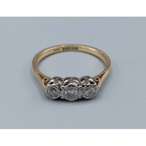 206 - An 18ct gold three stone diamond ring, the three diamonds within a pierced setting, 2.7gms, ring siz... 