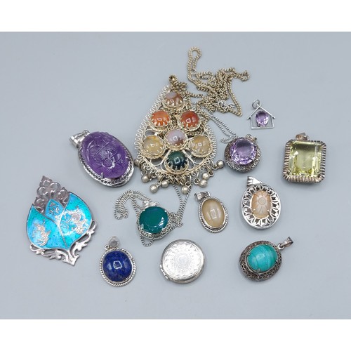 213 - A collection of silver pendants and brooches set various stones