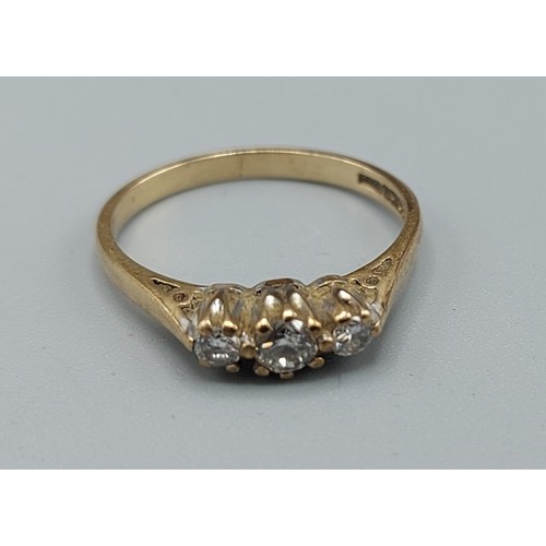 216 - A 9ct gold three stone diamond ring, ring size L, 1.7gms