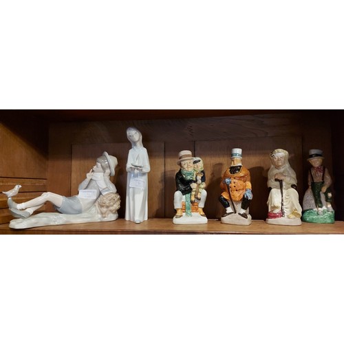 11 - A Lladro porcelain figure of a boy together with a collection of character jugs and two pin dolls