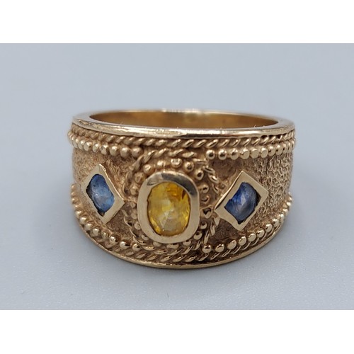 77 - A 9ct gold dress ring set with a central Citrine flanked by Sapphire, 8gms, ring size O