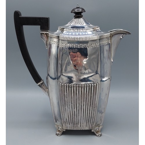 93 - A Victorian silver coffee pot of half lobed form with engraved band and ebonised handle, London 1888... 