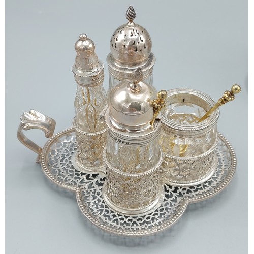 94 - A pair of Victorian silver Cruet stands of pierced form, each with four glass and silver mounted con... 