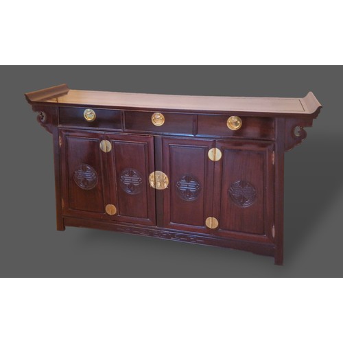 238 - A Chinese hardwood sideboard, the shaped top above three drawers and two cupboards doors with carved... 