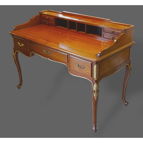 240 - A hardwood writing desk, the super structure with four drawers above a moulded top and three drawers... 