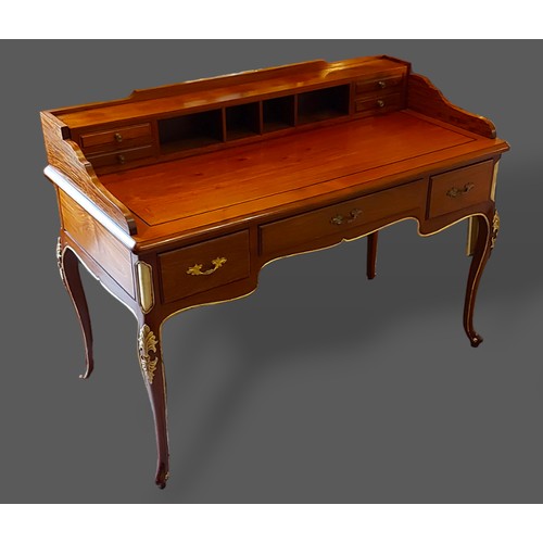 240 - A hardwood writing desk, the super structure with four drawers above a moulded top and three drawers... 