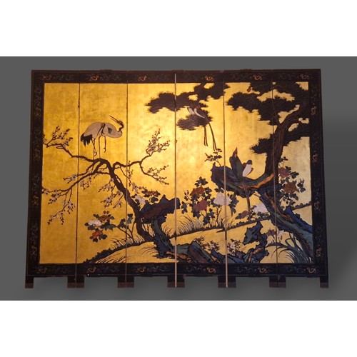 243 - A Chinese lacquered six fold screen, both sides decorated with birds amongst foliage and highlighted... 