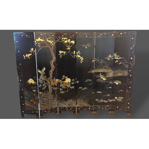 243 - A Chinese lacquered six fold screen, both sides decorated with birds amongst foliage and highlighted... 