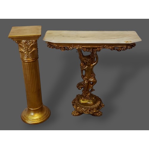 246 - A French gilded console table with a marble top above a figural column together with a gilded Torche... 