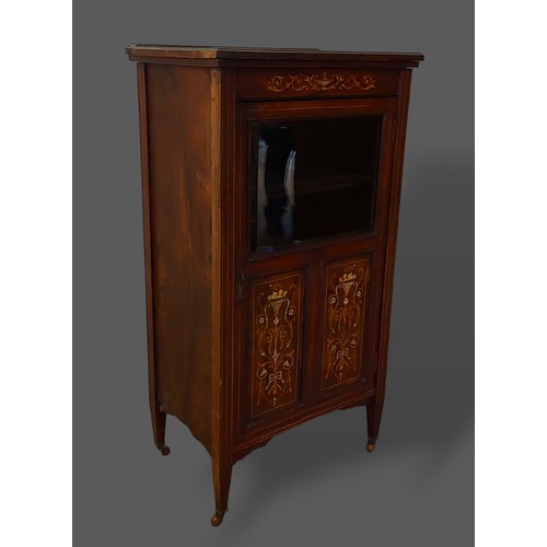 249 - An Edwardian Rosewood and marquetry inlaid music cabinet with a partly glazed door enclosing shelves... 