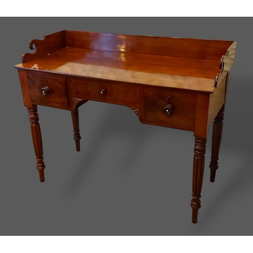 250 - A William IV mahogany washstand, the shaped galleried back above three drawers raised upon turned re... 