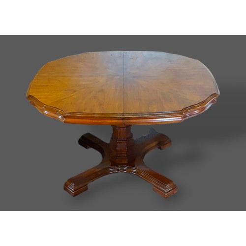 256 - A 1930's oak drawer leaf extending dining table raised upon turned legs with stretchers, together wi... 