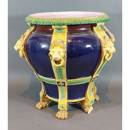 9 - A Minton Majolica jardiniere with lion mask ring handles upon a Cobalt blue ground, 28cms tall