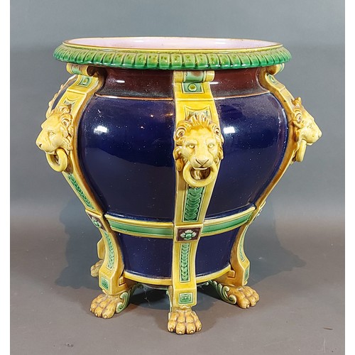 9 - A Minton Majolica jardiniere with lion mask ring handles upon a Cobalt blue ground, 28cms tall