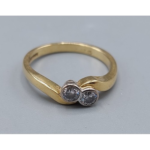 125 - An 18ct gold Diamond crossover ring, set with two Diamonds, 3.3gms, ring size L