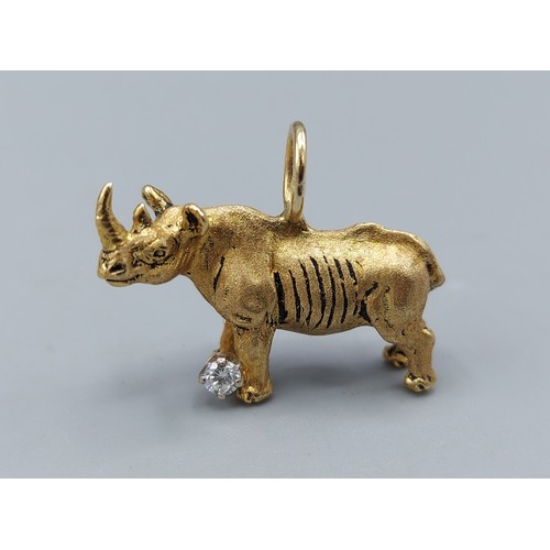 128 - An 18ct gold pendant in the form of a Rhinoceros set with a solitaire Diamond, 13.8gms