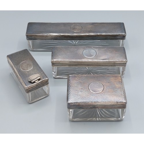 151 - A set of four Victorian silver topped and glass dressing case boxes, London 1868