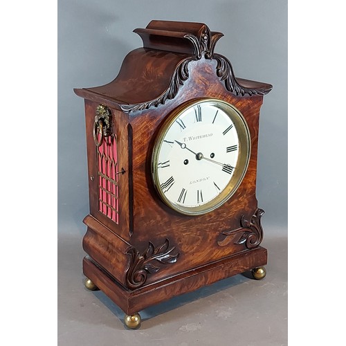 227 - A William IV mahogany case bracket clock, the carved shaped case with side ring handles, the dial in... 