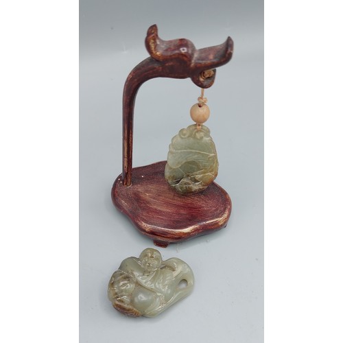 217 - A Chinese Jade carving with hardwood stand, 5cms long together with another Chinese jade carving, 5c... 