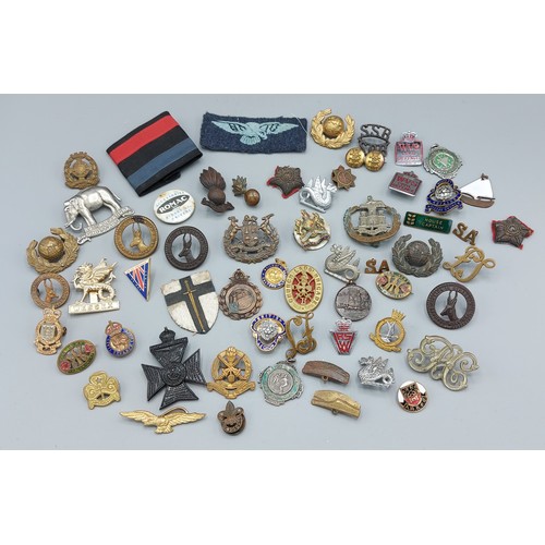 229 - A collection of military cap badges and other related items