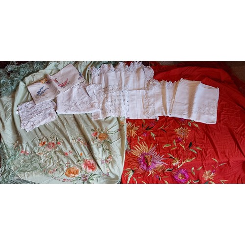 234 - A silk embordered shawl together with another similar and a small collection of linens