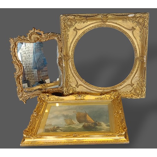 236 - A Rococo style gilt framed wall mirror, 59cms x 40cms, together with a gilt frame and a gilt framed ... 