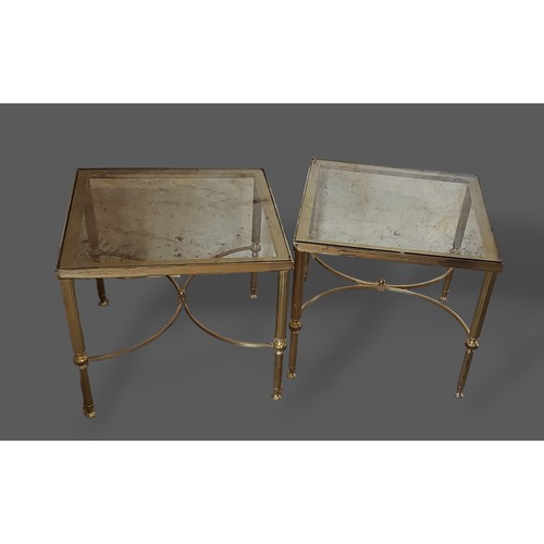 319 - A pair of patinated metal and leather two tier tables together with a pair of glass top side tables