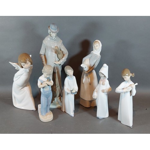 22 - A Lladro porcelain figure of a man with violin together with six Lladro figures and a large Lladro m... 